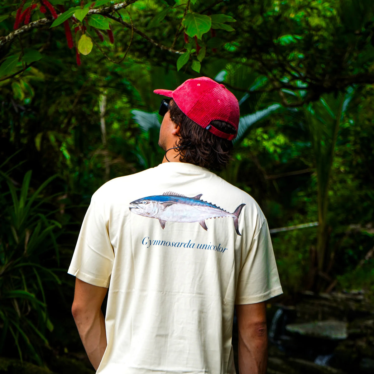 Dogtooth Tuna tee worn in tropical rainforest with a corduroy cap